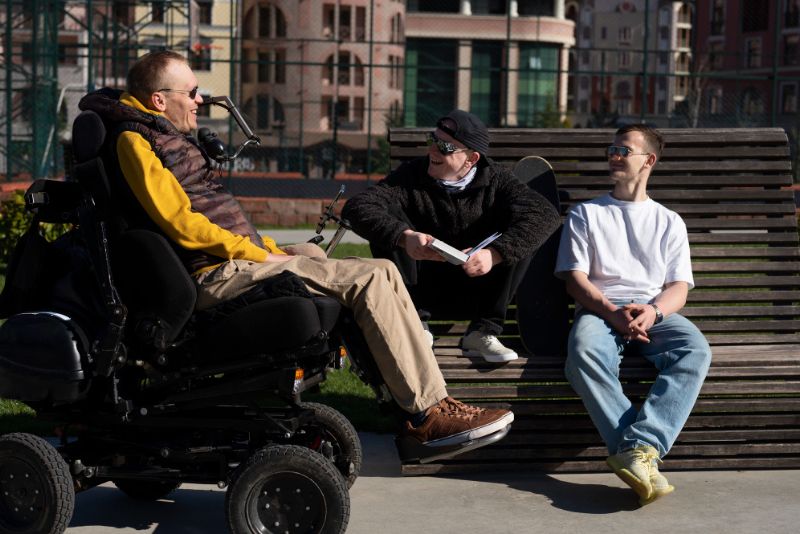Disabled man chatting with friends